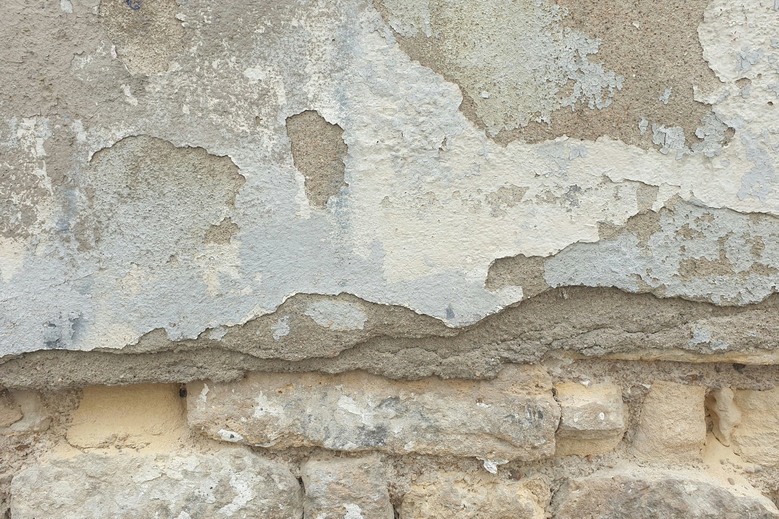 Innenwand im unteren Bereich mit bröckelndem Putz nahe dem Boden